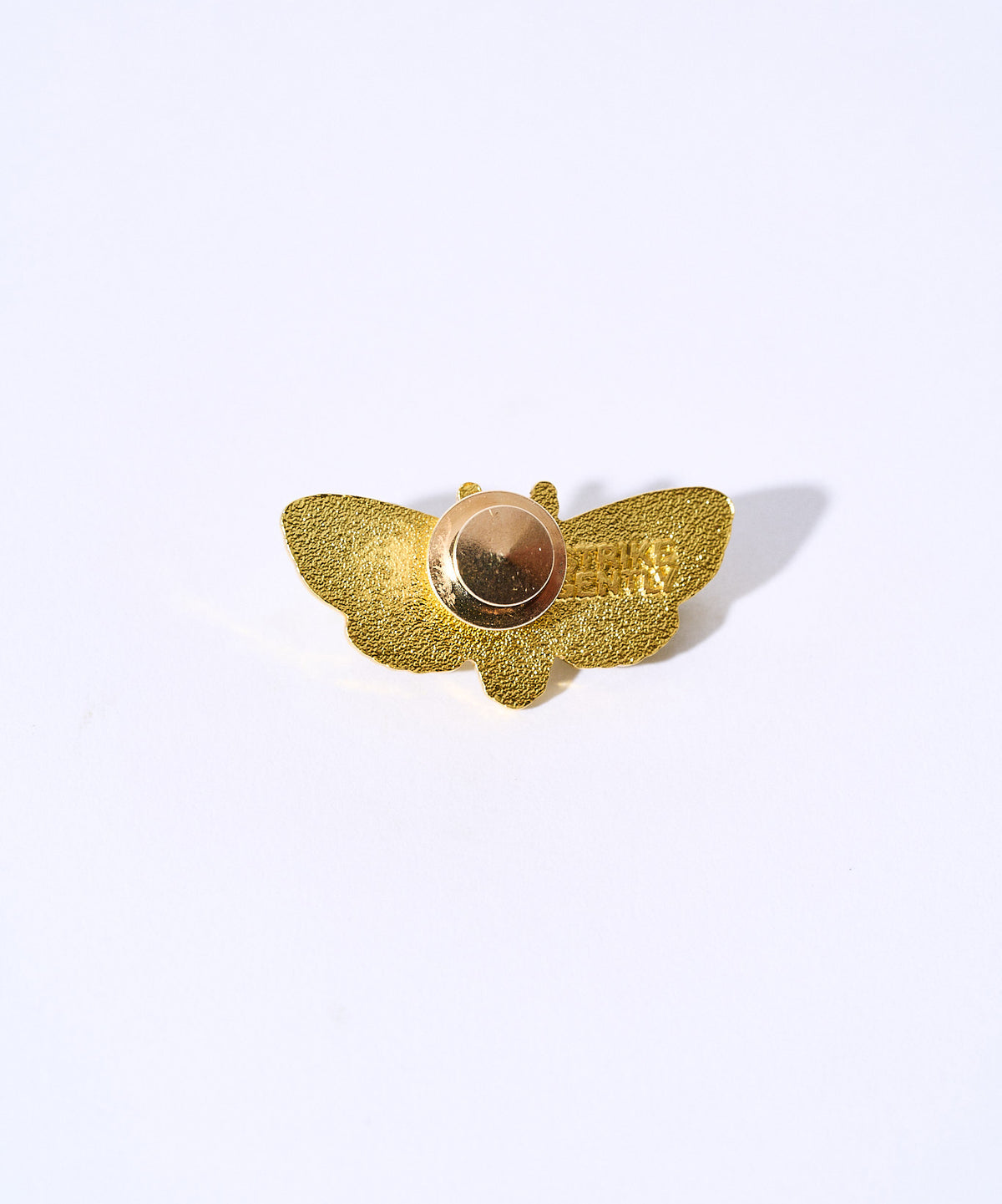 Back of the Death's Head Moth pin showing the gold glitter backing and gold clutch