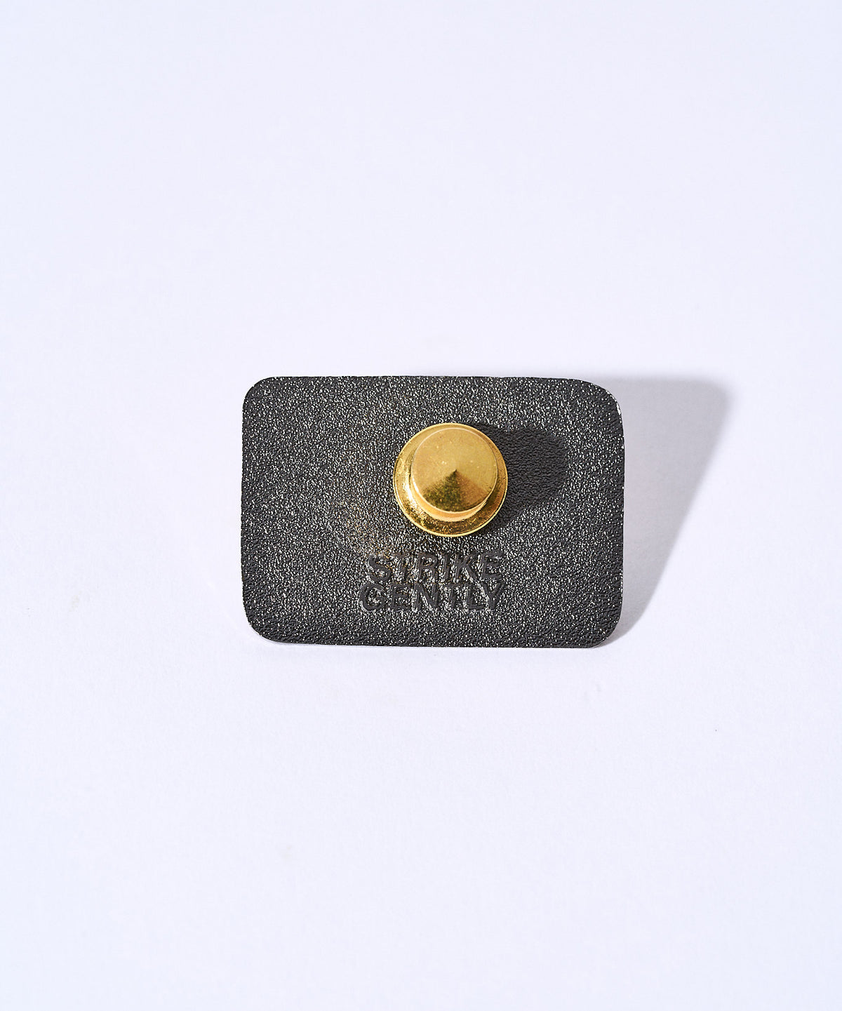 Back of the Hello, I'm Tired pin showing the gold rubber clutch and Strike Gently backstamp