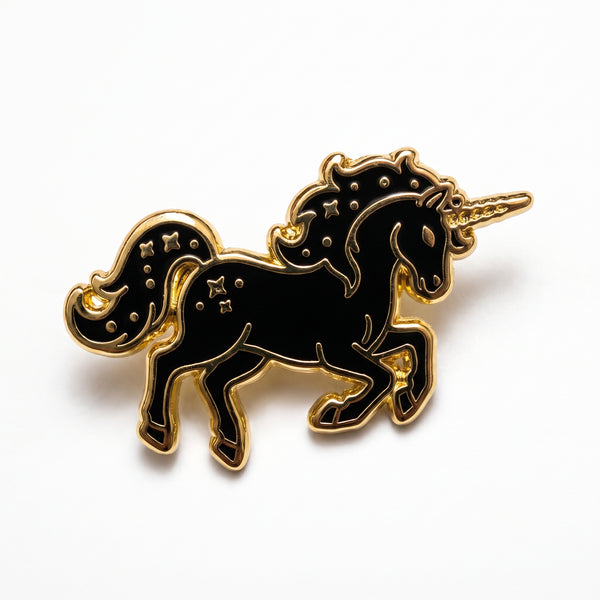 Black Unicorn enamel pin, a galloping black unicorn with a gold horn, mane and star markings