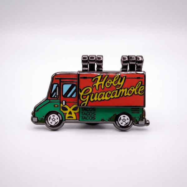 Holy Guacamole Taco Truck enamel pin, a red and green taco truck with yellow Holy Guacamole lettering and a luchador mask, hinged side closed