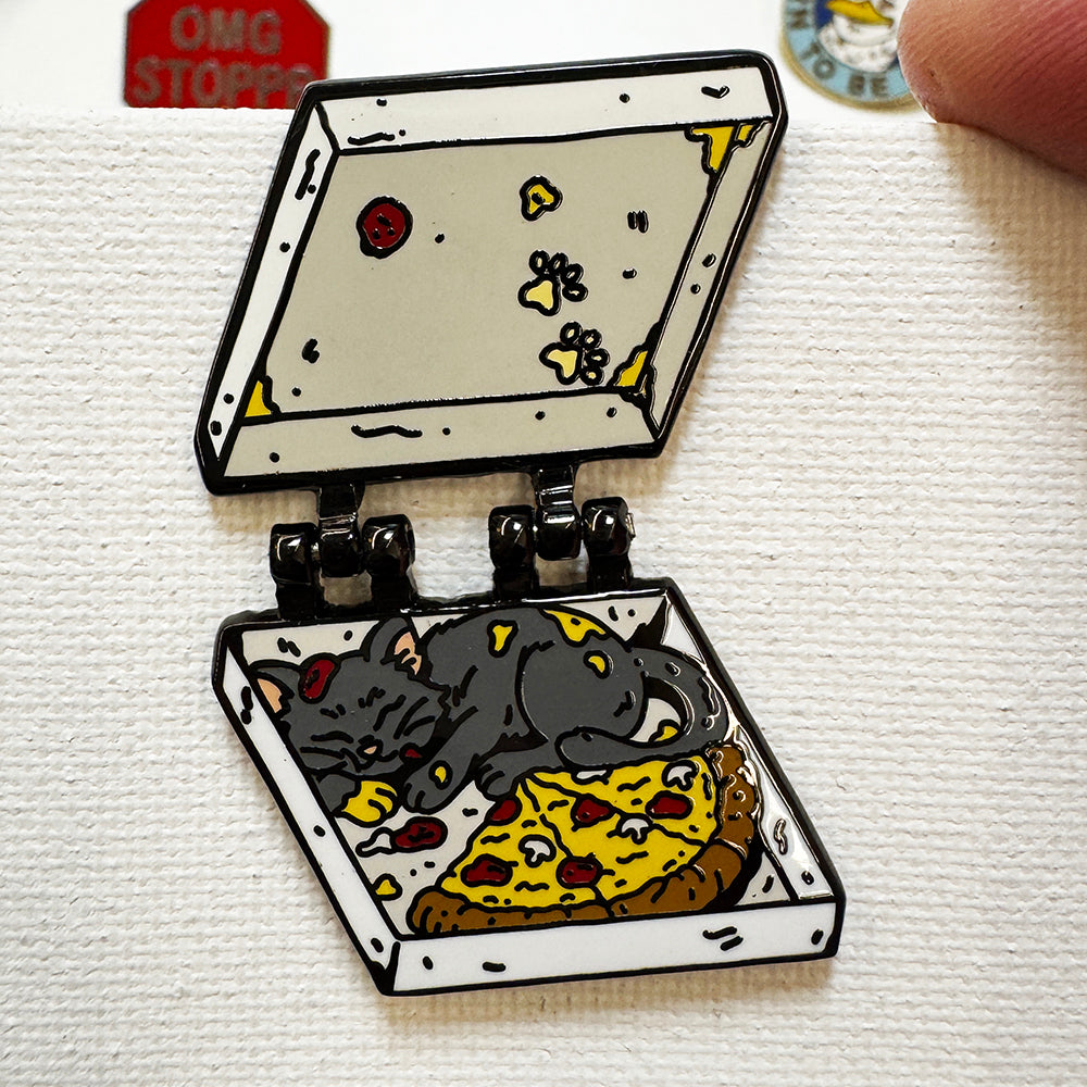 Pizza Cat deluxe enamel pin with the lid opened on hinges, showing a gray cat curled up on a pizza inside the box