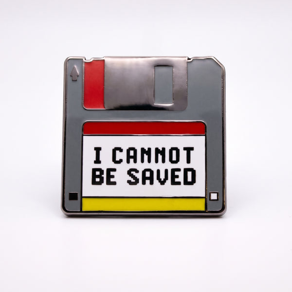 I Cannot Be Saved enamel pin, a gray floppy disk with a red shutter tab and a white label reading I Cannot Be Saved