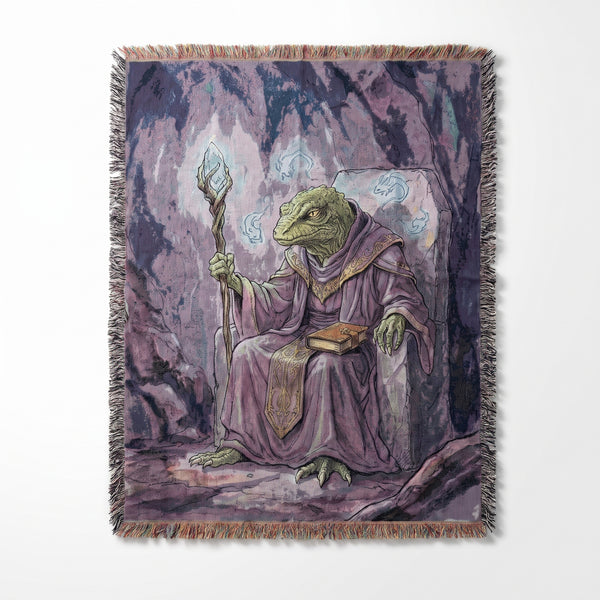 Lizard Wizard woven blanket showing a green lizard in purple robes on a stone throne holding a glowing crystal staff in a misty cave