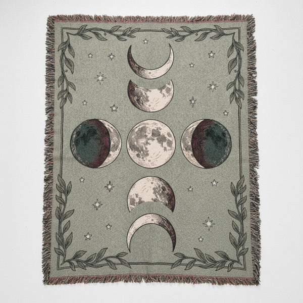 Woven sage green blanket with moon phases and stars