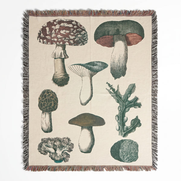Vintage Mushroom woven blanket showing antique engraved mushrooms including fly agaric, boletes and coral fungus on a cream background