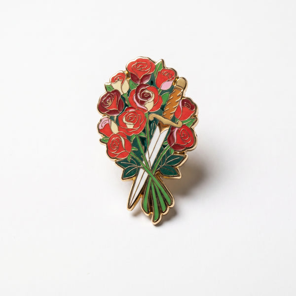 Roses And Dagger enamel pin, a bouquet of red and pink roses with a dagger hidden among the green stems