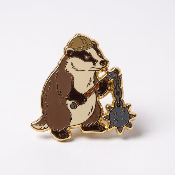 Warrior Badger enamel pin, a scowling badger in a riveted viking helmet swinging a spiked flail