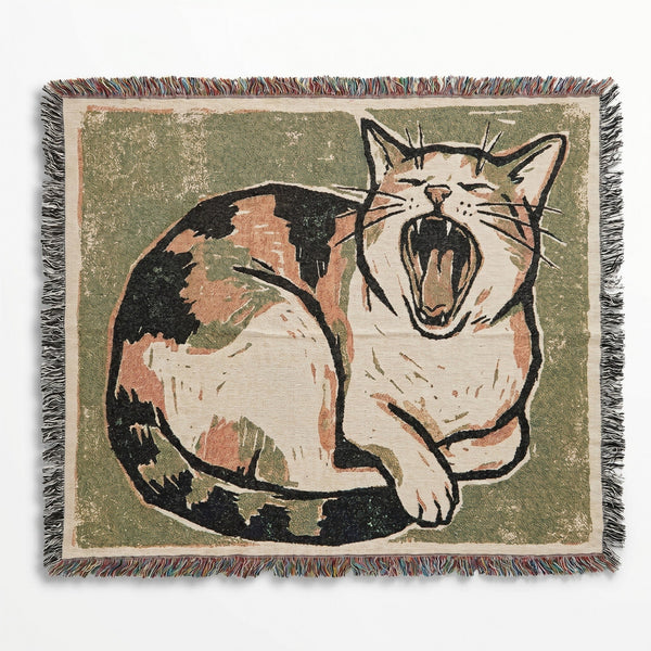 Woven blanket with a cat design on a green background