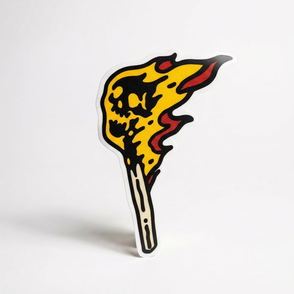 Lit match sticker with skull-shaped flames