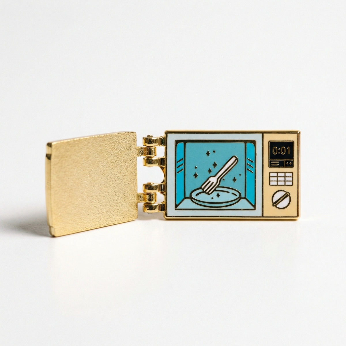 Fork In The Microwave enamel pin with the gold door swung open, showing a fork on a plate inside the microwave