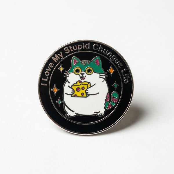 Round enamel pin featuring a fat cat holding cheese with text I Love My Stupid Chungus Life