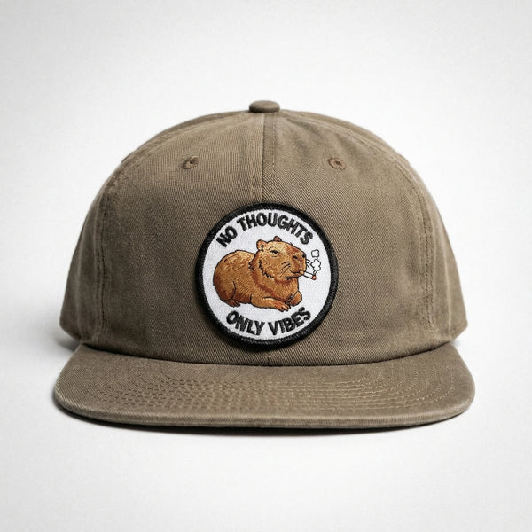Brown washed cotton hat with an embroidered capybara patch that says no thoughts only vibes