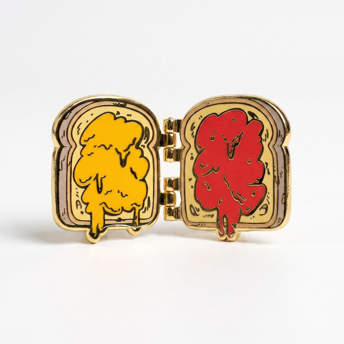 PB&J enamel pin opened, showing peanut butter on one slice and red jelly on the other