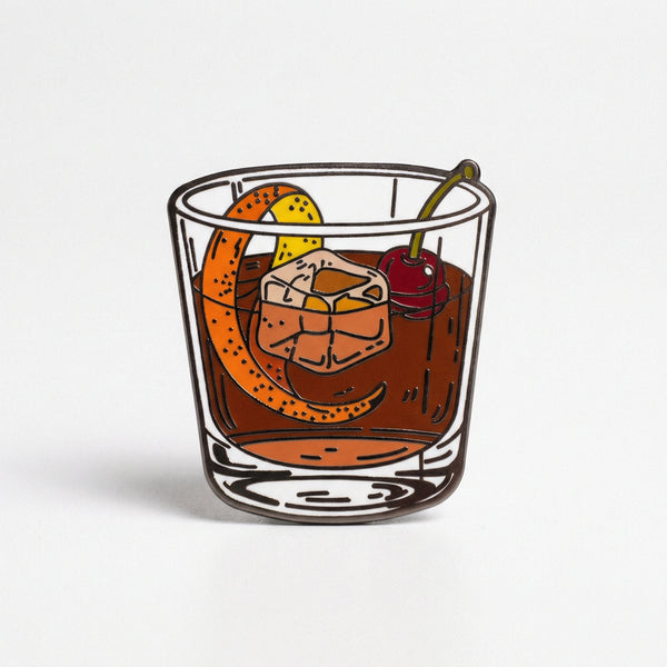 Enamel pin design of an Old Fashioned cocktail in a rocks glass with garnish