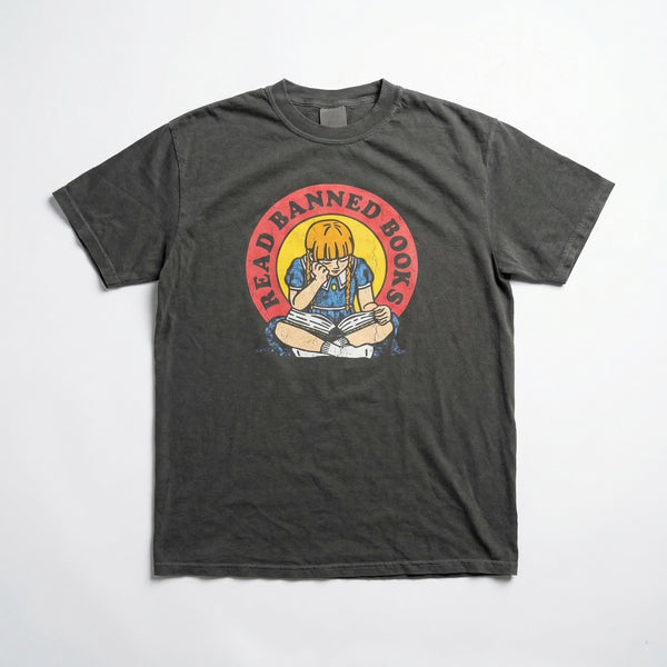 Charcoal gray t-shirt with a vintage-style circular graphic showing a girl reading and the words Read Banned Books.