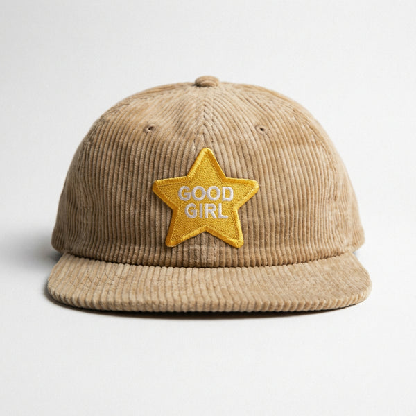 Beige corduroy hat with yellow star patch reading GOOD GIRL