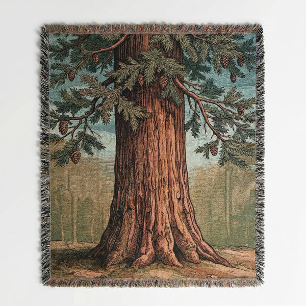 Woven cotton blanket with a sequoia tree and pinecone illustration.