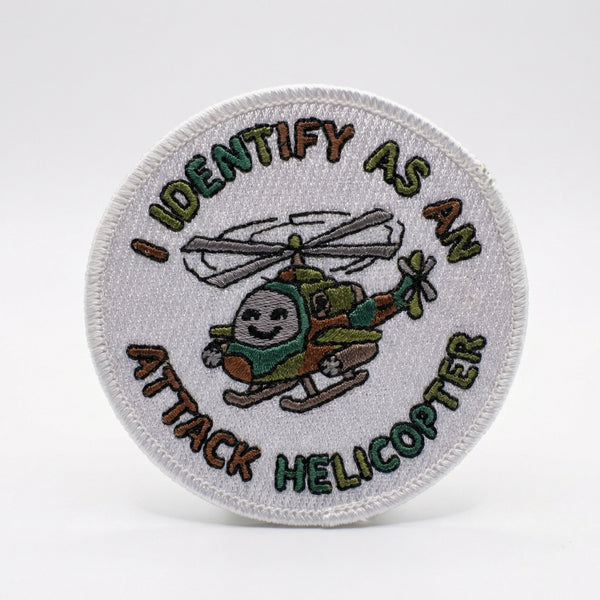 Round embroidered patch with text I IDENTIFY AS AN ATTACK HELICOPTER and a cartoon helicopter.