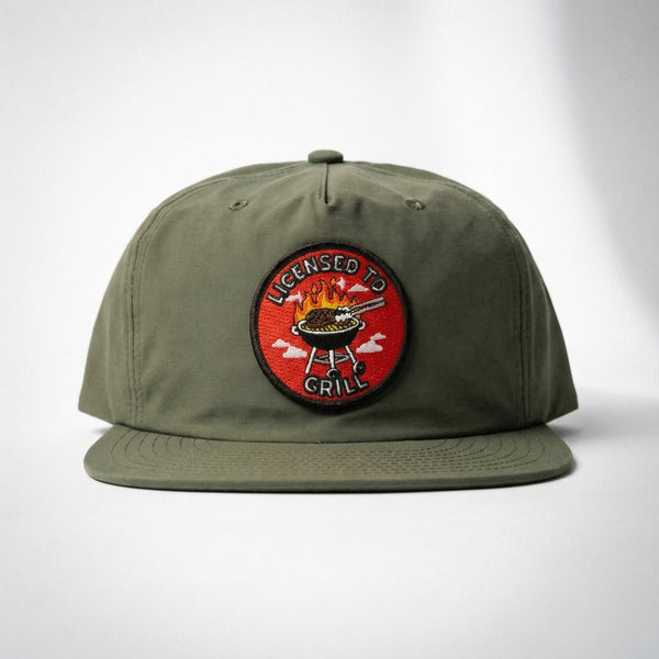 Olive green nylon snapback hat with Licensed To Grill circular patch