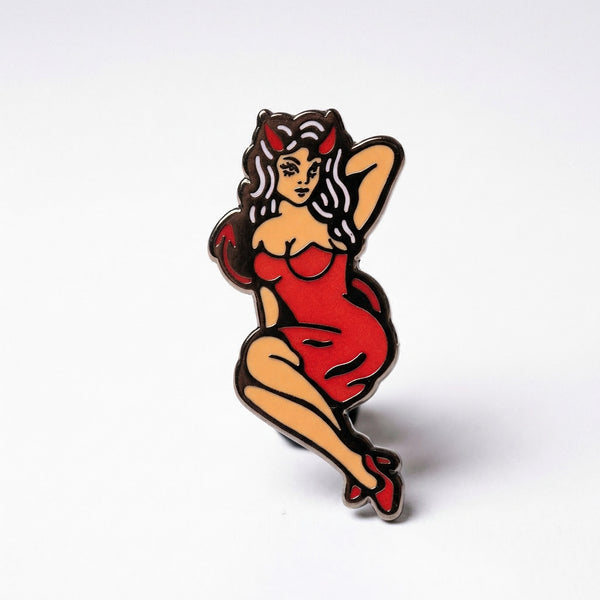 Devil pin-up girl enamel pin with red dress and horns