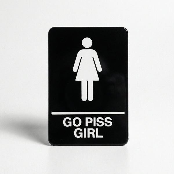 Rectangular black enamel pin with female restroom icon and text GO PISS GIRL