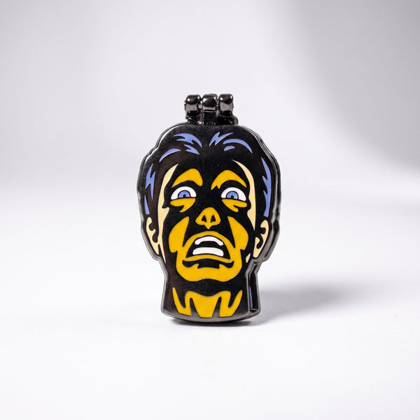Skin Deep Deluxe enamel pin, a hinged horror-comic head showing a terrified yellow face with wild purple hair