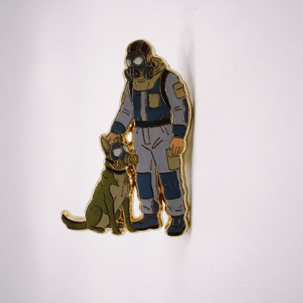 Gas Mask Buddies enamel pin, a man in gray and blue coveralls and a gas mask standing beside his dog, also in a gas mask