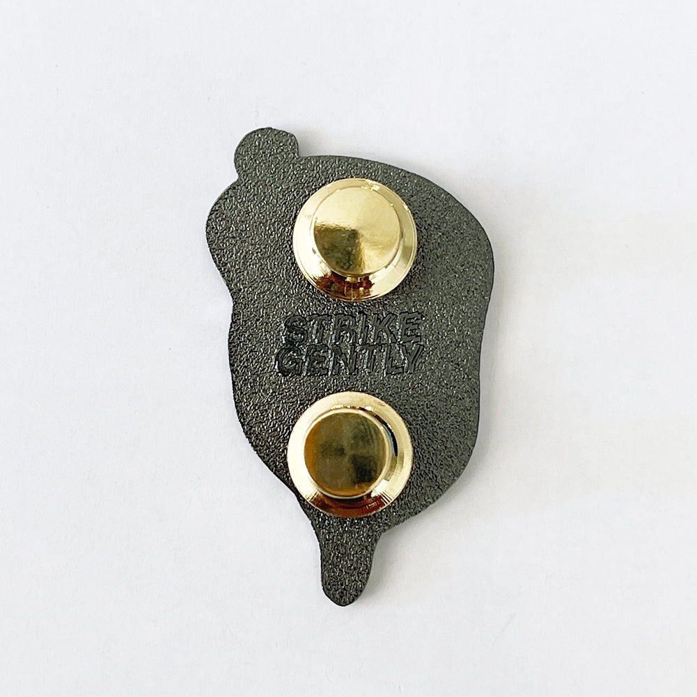 Back of the Persistence pin showing the black backing, two gold clutches and Strike Gently backstamp